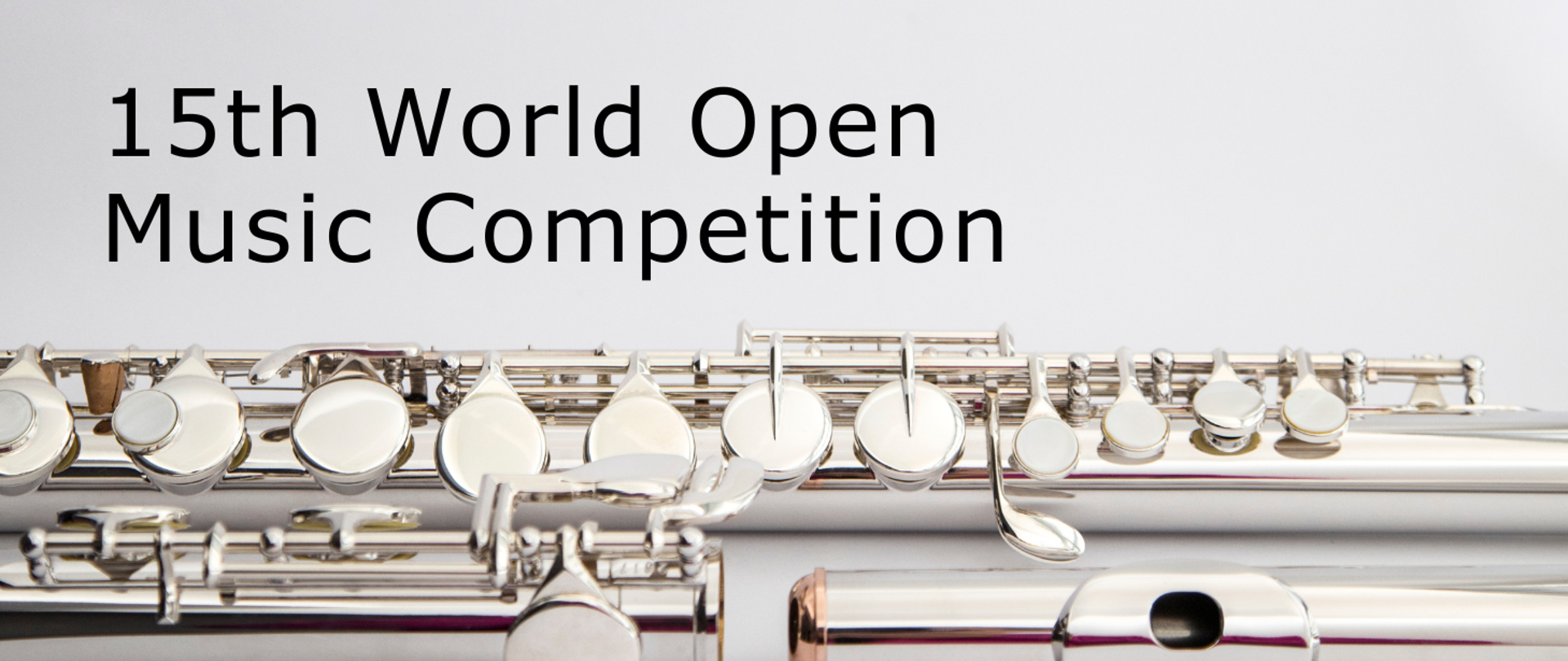 Srebrny flet na białym tle a nad nim czarny napis 15th World Open Music Competition