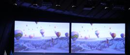 Szczyt Cyfrowy ONZ – IGF 2021. Sześć osób siedzi na scenie. Za nimi dwa ekrany, na których wyświetlane są kolorowe lampiony nad ośnieżonymi szczytami górskimi. Fot. PAP