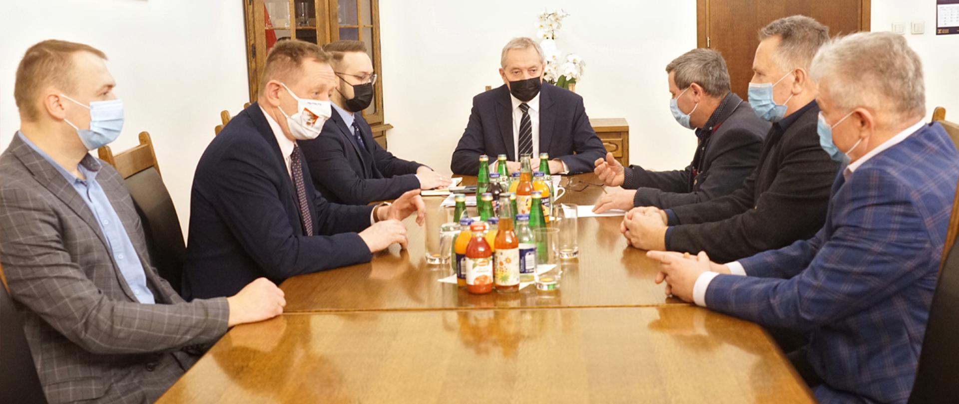 Wicepremier Henryk Kowalczyk siedzący przy stole z rolnikami i producentami trzody chlewnej