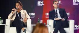 Wiceminister rozwoju i technologii Marek Niedużak siedzący w fotelu na dyskusji EFNI'21 w Sopocie, po jego lewej stronie wiceprezes Orange Bożena Leśniewska