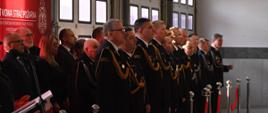 Zaproszeni goście oraz Śląski Komendant Wojewódzki stoją podczas uroczystej zbiórki na tyrbunie honorowej