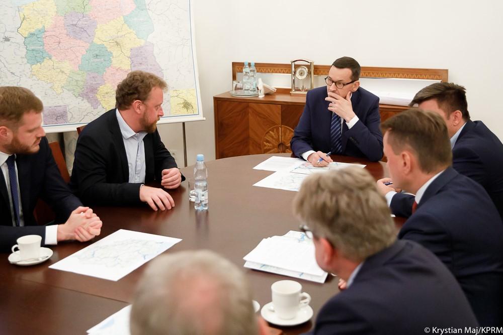 Premier słucha ministrów na sztabie kryzysowym.