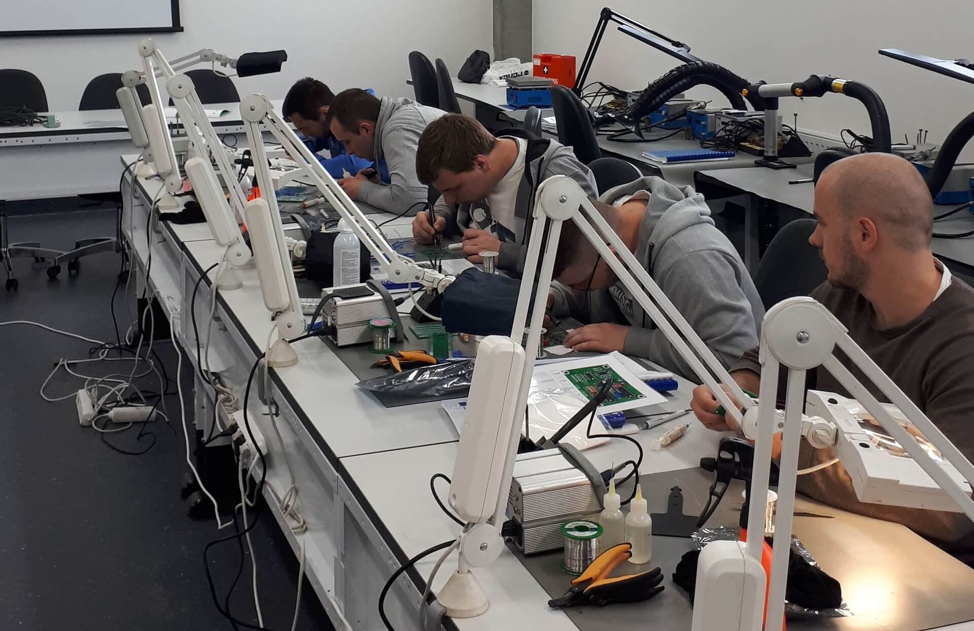 A group of students are working at the engineering workbench