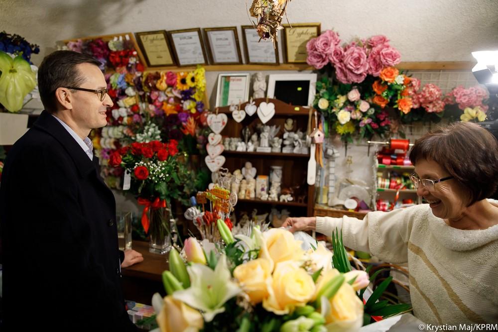 Premier Mateusz Morawiecki kupuje kwiaty.