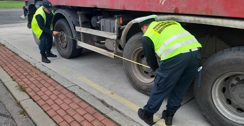 Inspektorzy mierzą rozstaw osi w ciężarówce