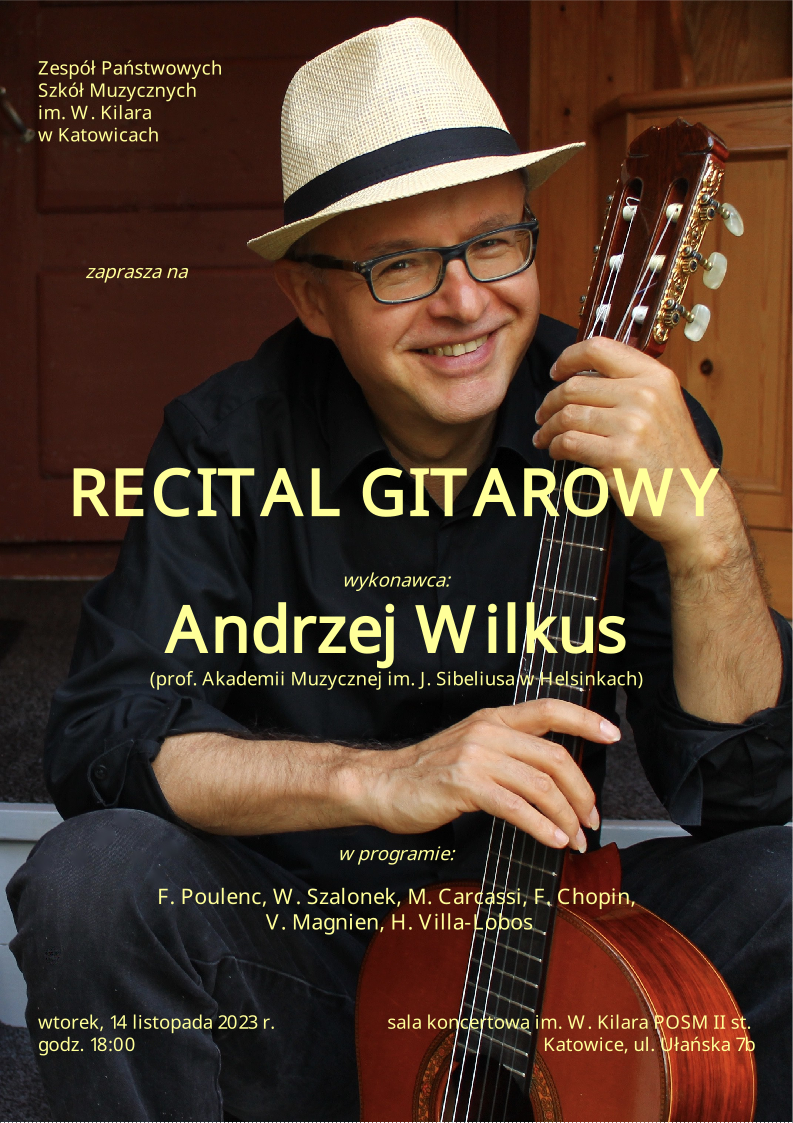 prof. Andrzej Wilkus w słomkowym kapeluszu i okularach trzymający gitarę