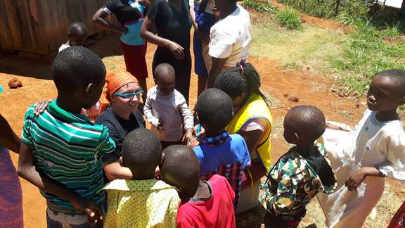 A volunteer talking with kids