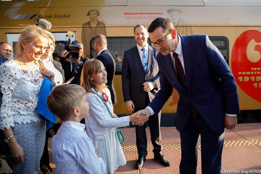 Premier wita się z dziećmi na Dworcu Kolejowym w Katowicach.