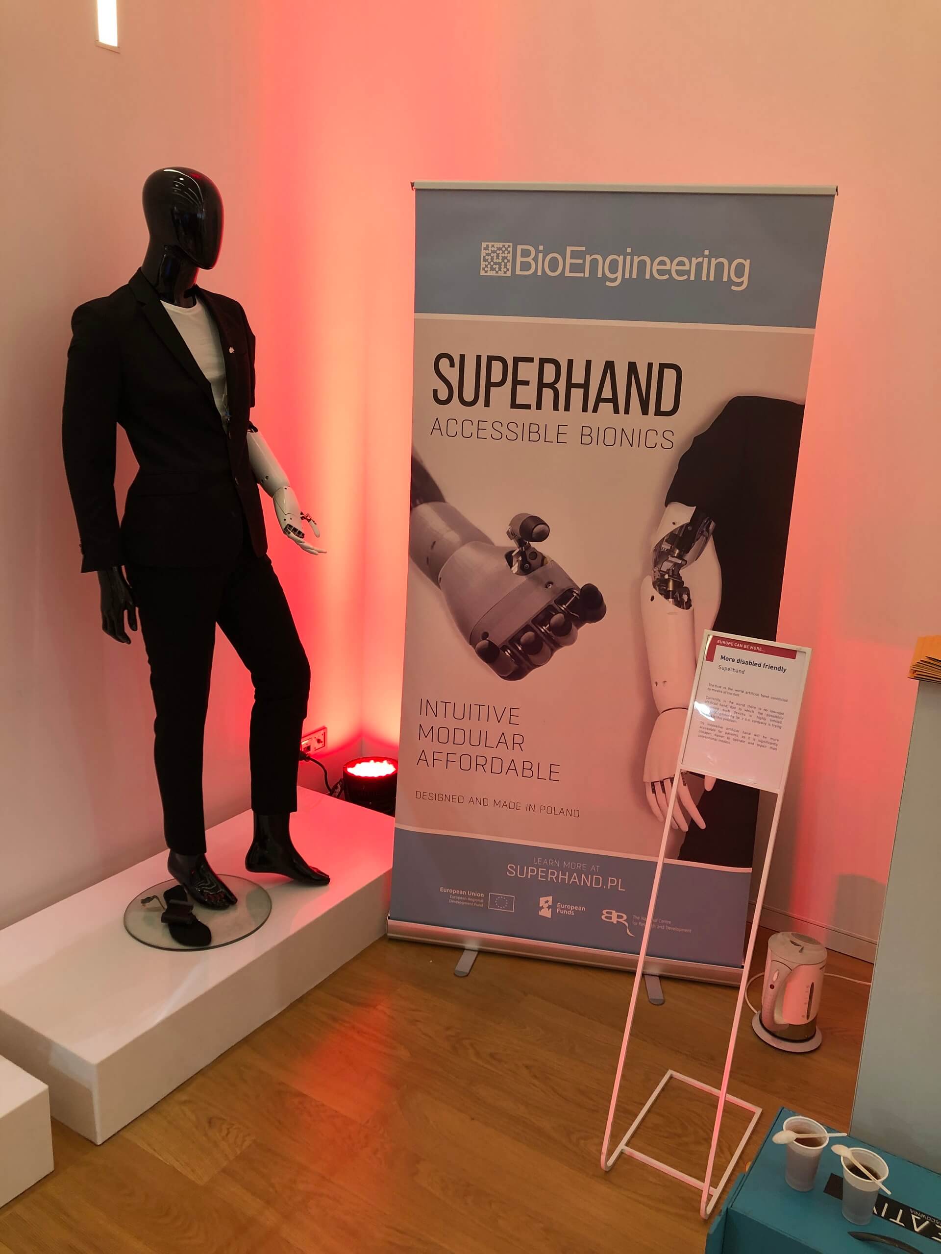 Bionic hand prosthesis on a mannequin, next to it the BioEngineering information poster