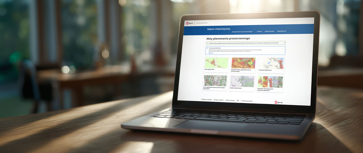 Obraz przedstawia laptopa, na którym jest wyświetlona strona główna Rejestru Urbanistycznego z ramkną umożliwiającą zapis do systemu powiadomień.