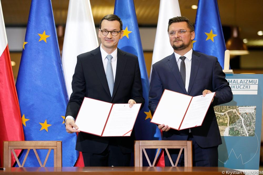 Premier oraz prezydent Katowic pokazują podpisany list intencyjny.