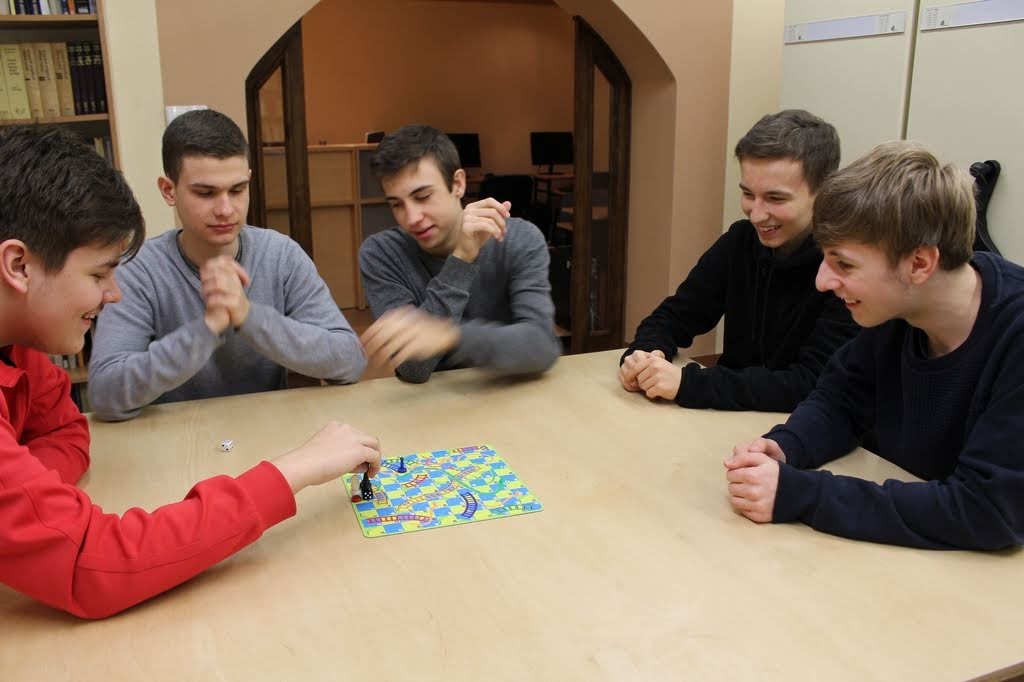 Grafika przedstawia uczniów ZPSM grających w gry planszowe