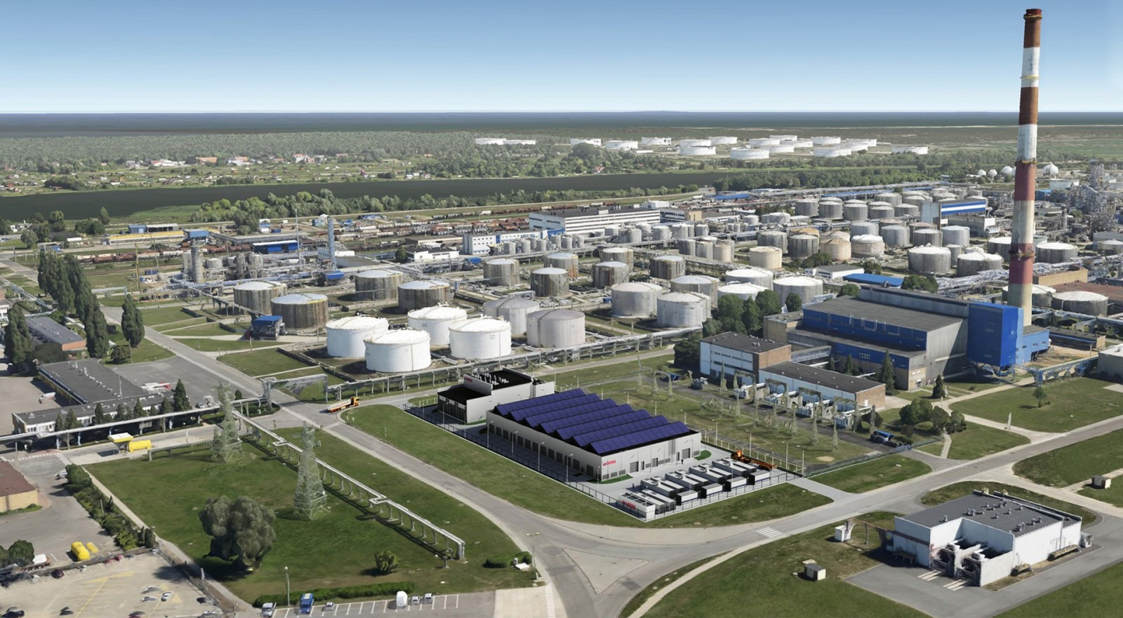 Widok z góry. Widać budynki zakładu produkcyjnego Green H2, w tym kominy i zbiorniki wodoru. 
