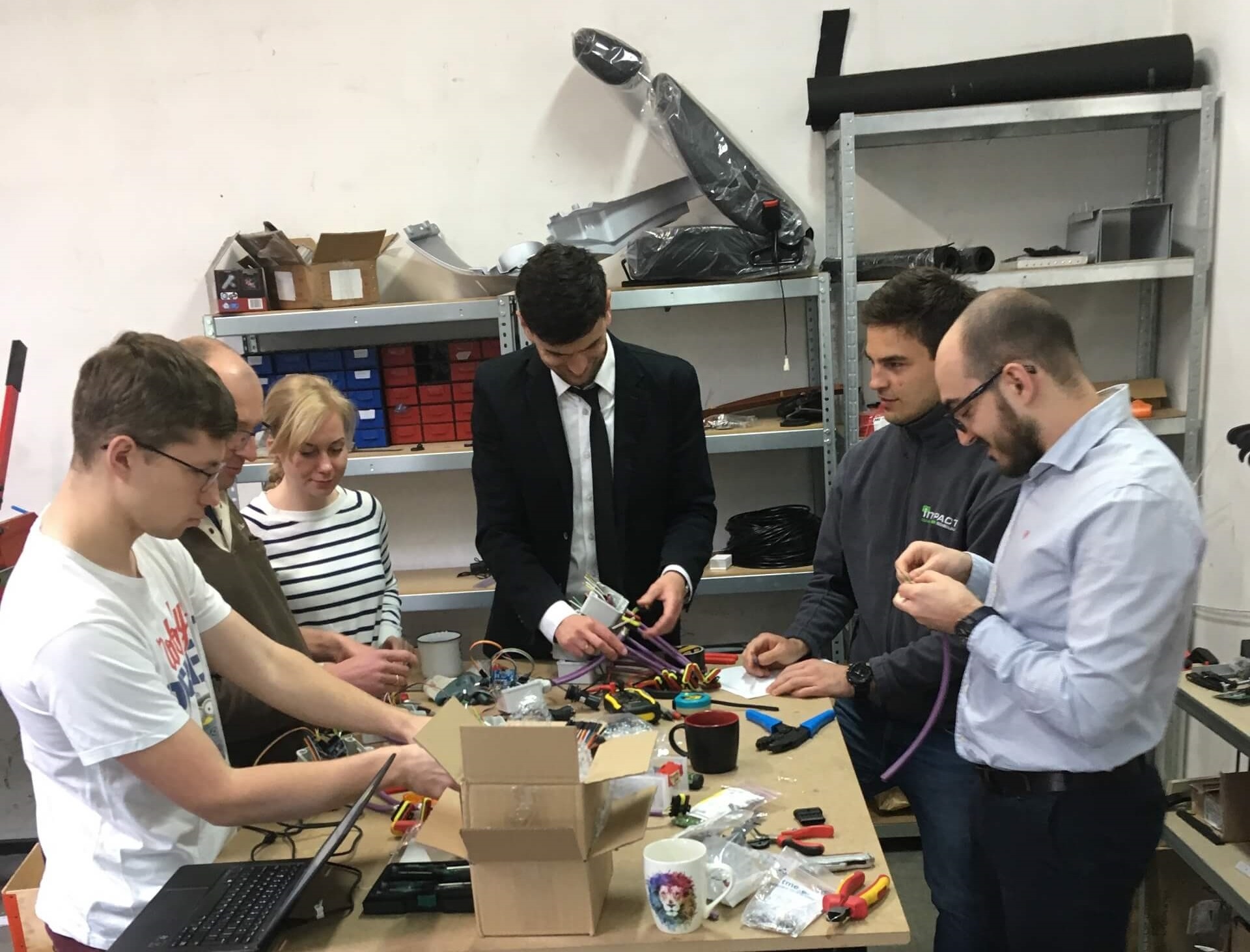 Sześć osób pracuje przy stole inżynierskim