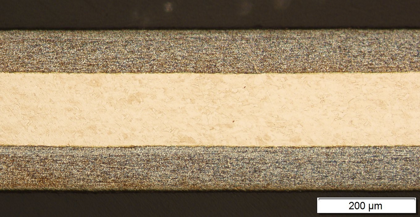 Fig.1_ The part of a cross-section of an Ag/Cu/ Ag alloy layered solder strip with a thickness of 0.3mm, obtained according to the developed technology, (Ag alloy - Ag49Cu27.5Zn20.5Mn2.5Ni0.5).