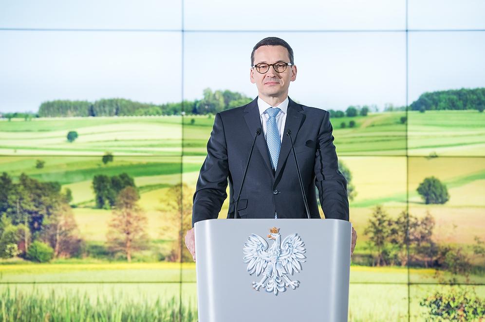 Premier Mateusz Morawiecki przy mównicy.