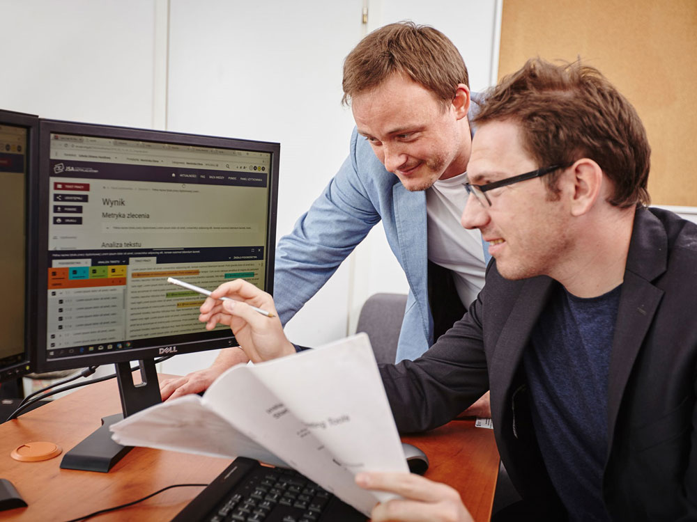 In the photo: Dr. Marek Kozłowski and Maciej Kowalski working at the computer