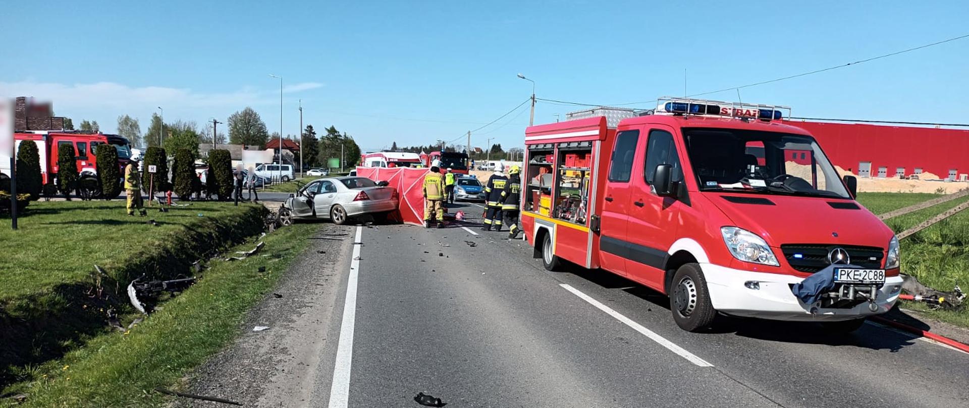 Widoczne miejsce zdarzenia uszkodzone pojazdy oraz służby podczas działań ratowniczych.