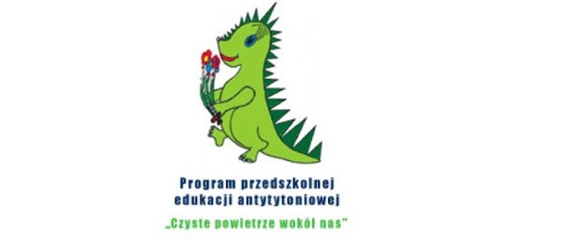 Na obrazku widoczny uśmiechnięty zielony dinozaur, niosący kolorowe kwiatki. Pod obrazkiem widnieje napis -Program przedszkolnej edukacji antytytoniowej "Czyste powietrze wokół nas"