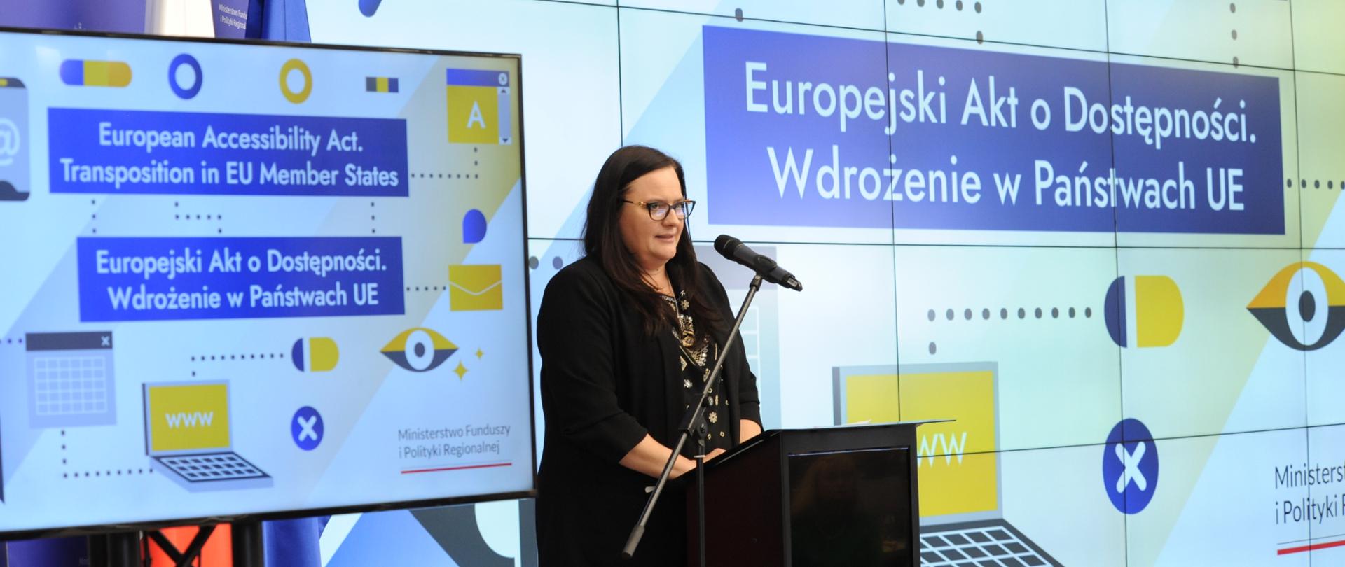 Wiceminister Małgorzata Jarosińska-Jedynak w mównicy z mikrofonem. Za nią na ekranie napis: "Europejski Akt o Dostępności".