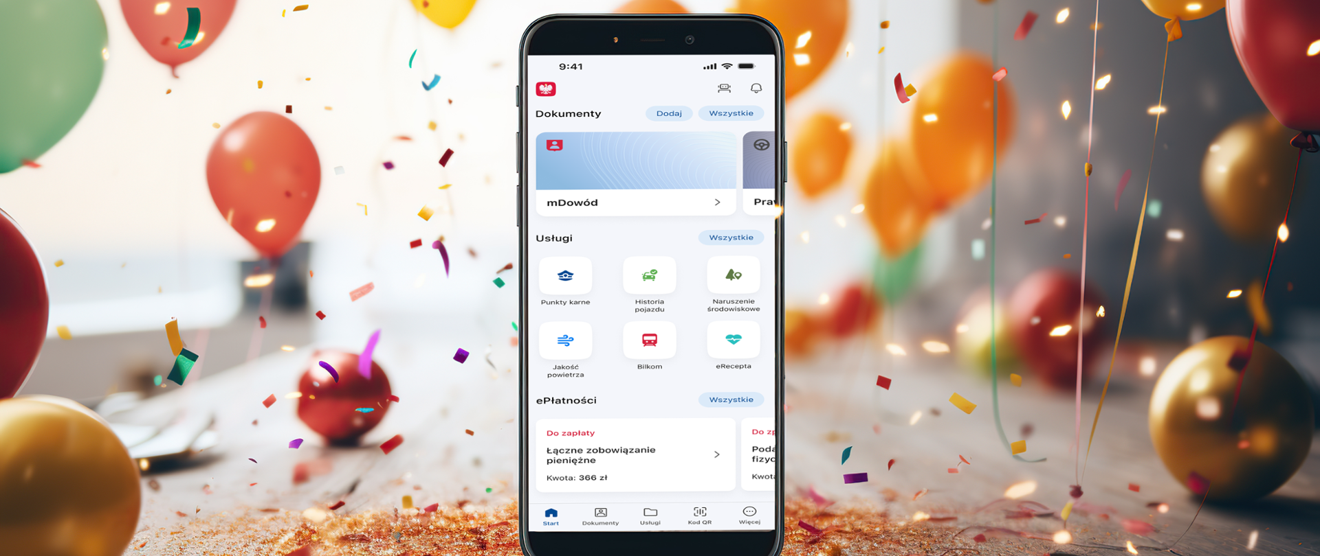 telefon z platformą ePłatności, w tle balony i konfetti z okazji świętowania pierwszego roku ePłatności