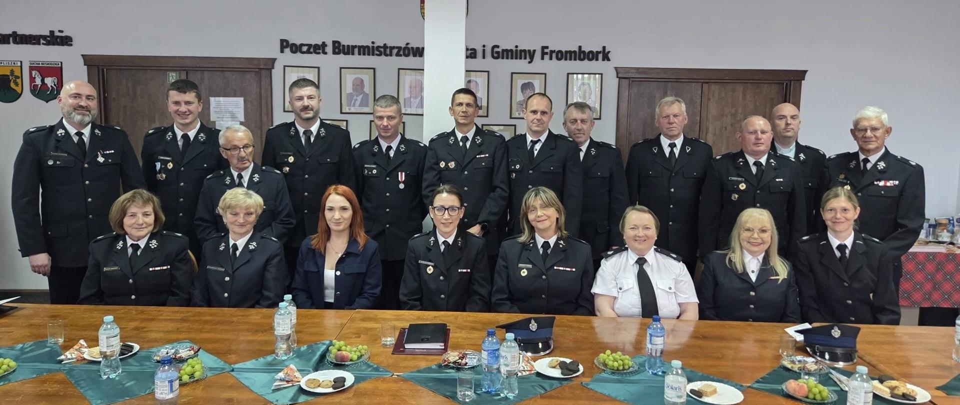 Na zdjęciu duża grupa druhen i druhów w ubraniach galowych.