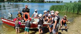 Dzieci oglądają łódź ratowniczą na jeziorze średzkim