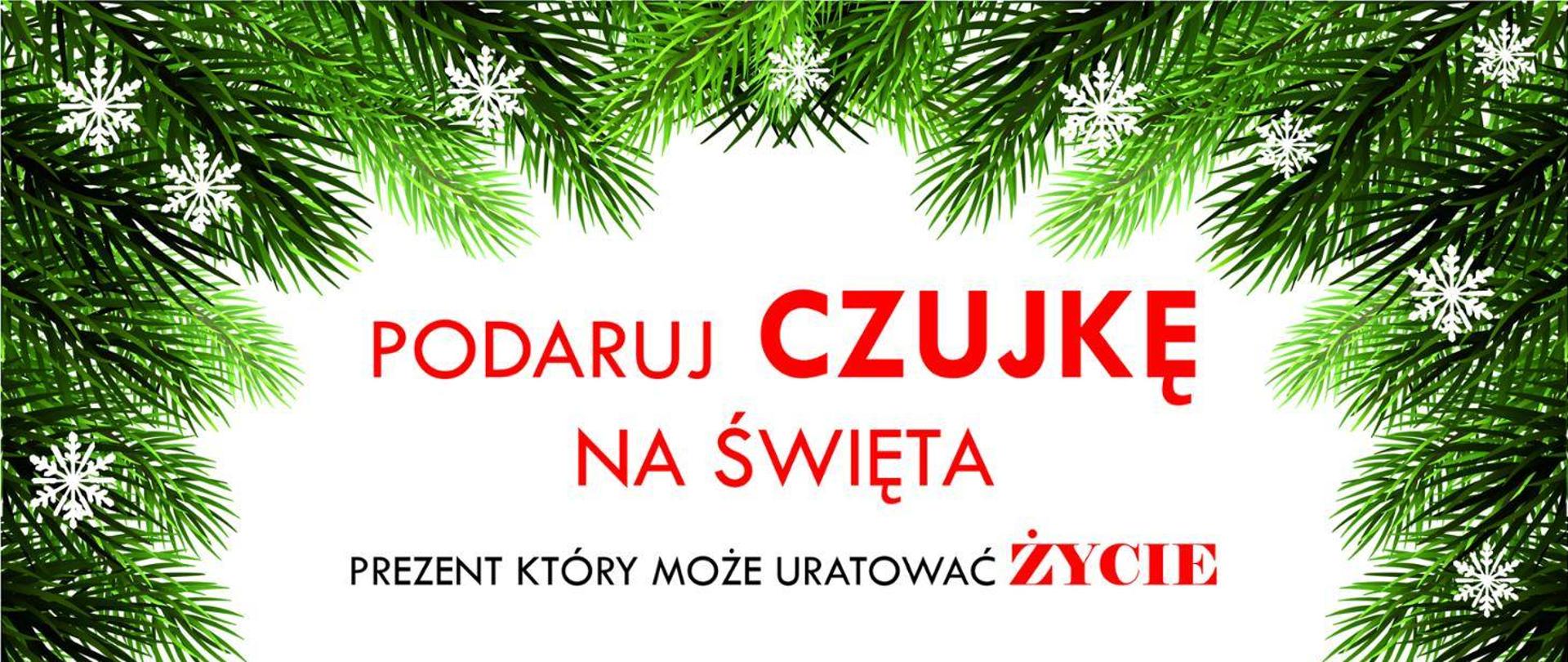 Plakat. Centralnie czerwone napisy, Podaruj czujkę na święta prezent który może uratować Życie. Boki i góra plakatu zielone gałązki choinki.