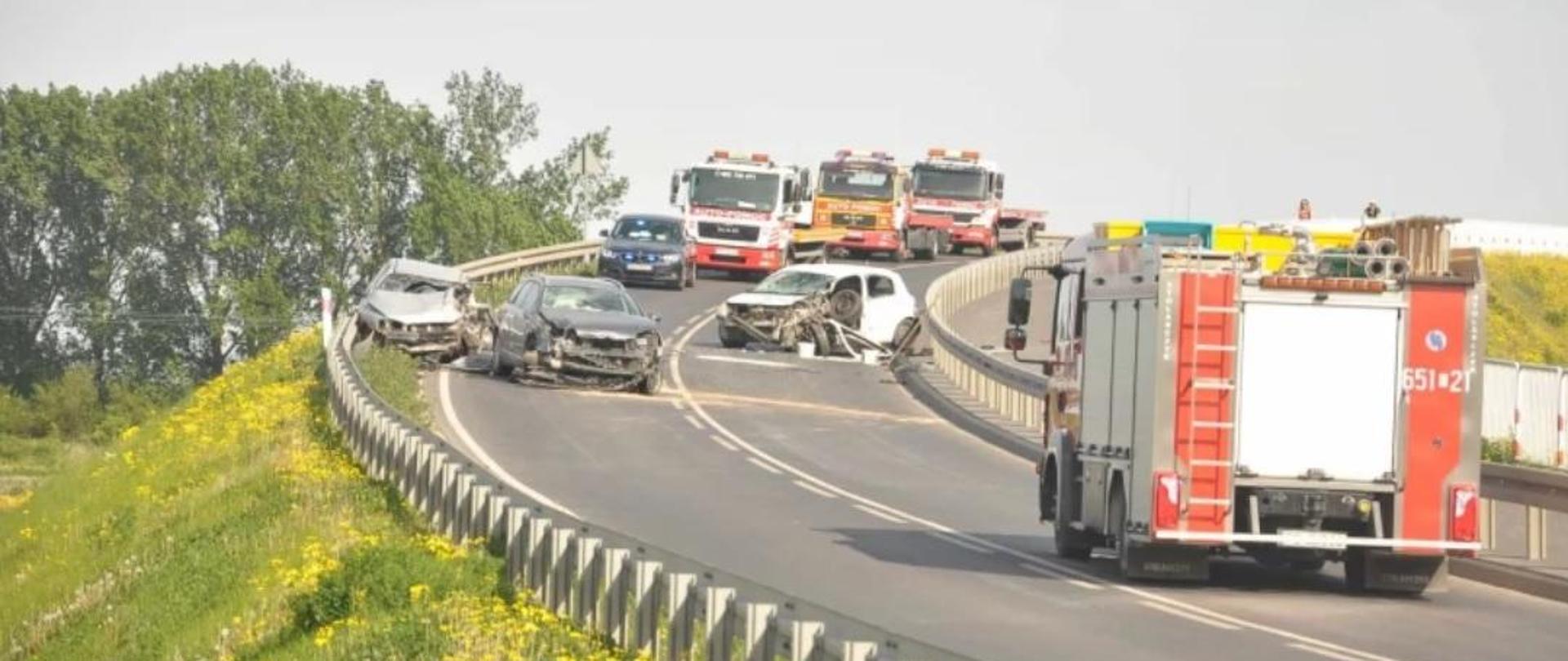 Zdjęcie przedstawia dwa samochody osobowe na wiadukcie po zderzeniu.