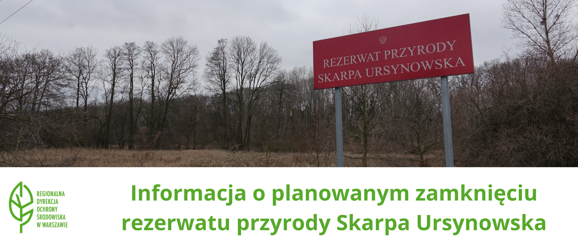 Panorama - w tle drzewa bez liści, z przodu czerwona tablica z nazwą rezerwatu