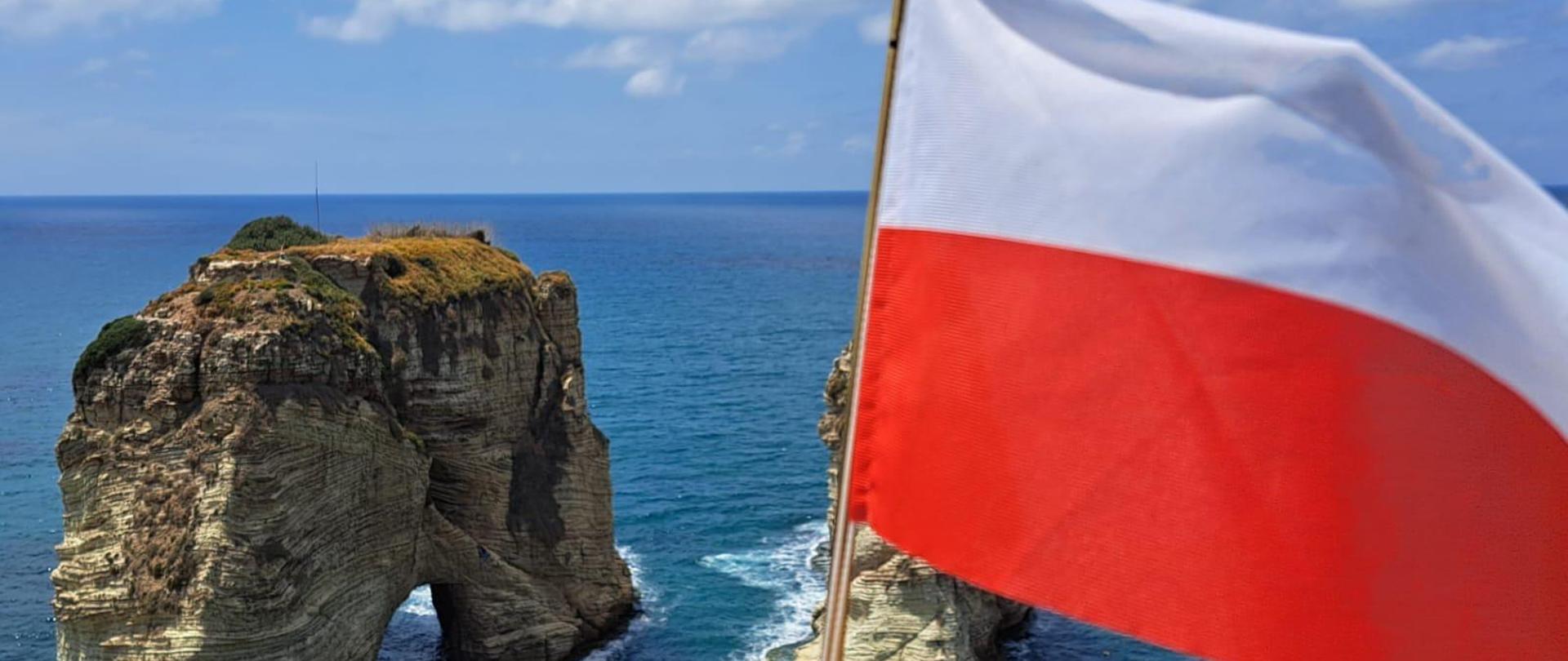 The Polish flag flying proudly against the iconic Pigeon Rocks of Beirut.