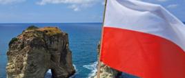 The Polish flag flying proudly against the iconic Pigeon Rocks of Beirut.