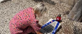 Polish Consul in Beirut Aneta Ananicz lighting a candle at the grave of Father Kantak at the Polish Military Cemetery in Beirut.
