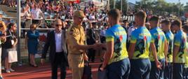 Widok z boku. Zastępca Małopolskiego Komendanta Wojewódzkiego PSP wręcza nagrody drużynie MDP OSP Przytkowice.