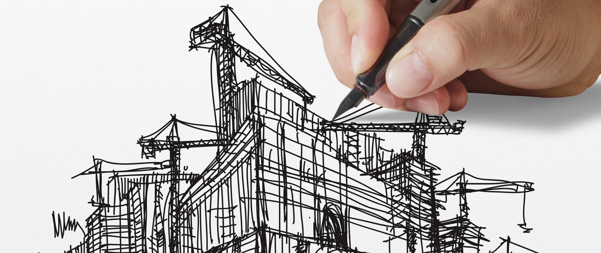 ręka rysująca rysunek architektoniczny na papierze