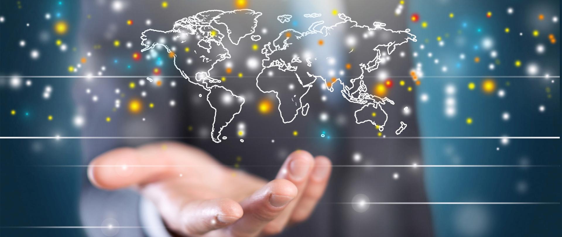 Kontury mapy świata nad męską ręka