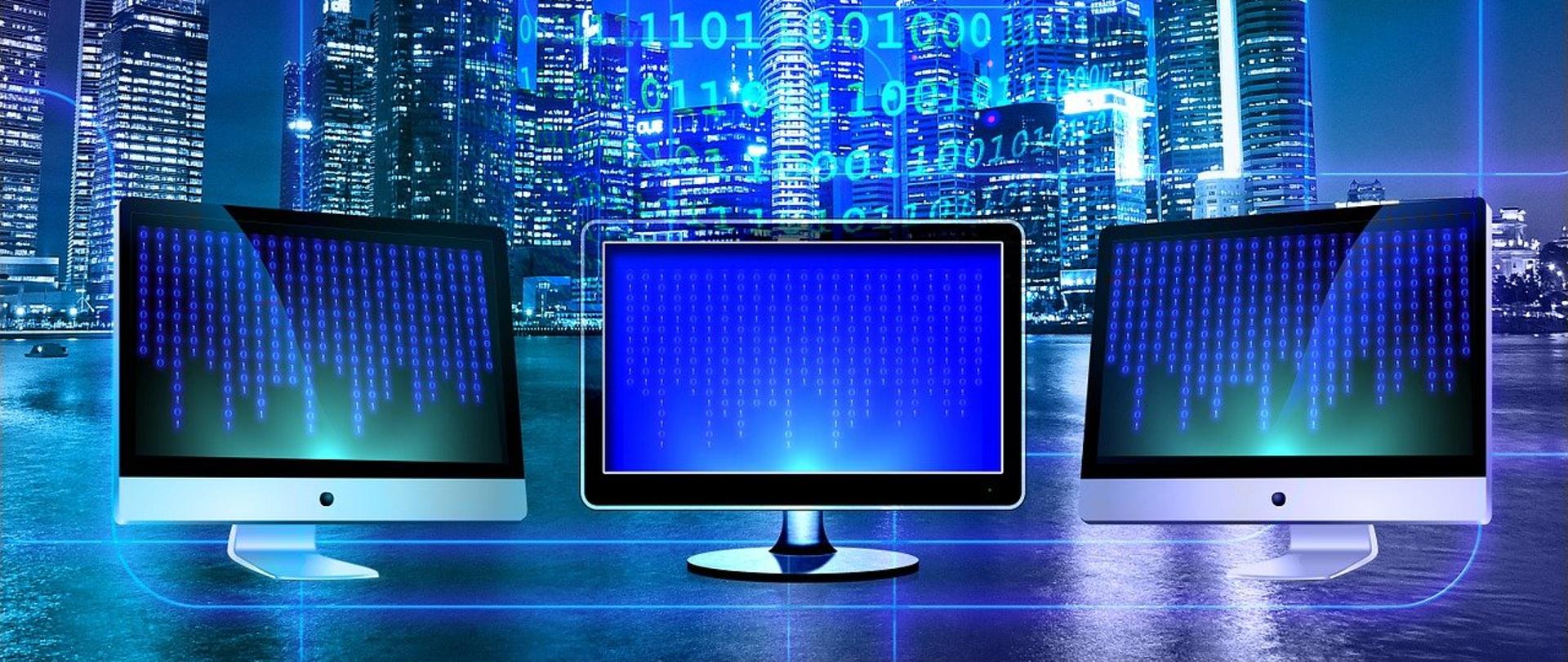 Trzy monitory, w tle miasto i kod binarny