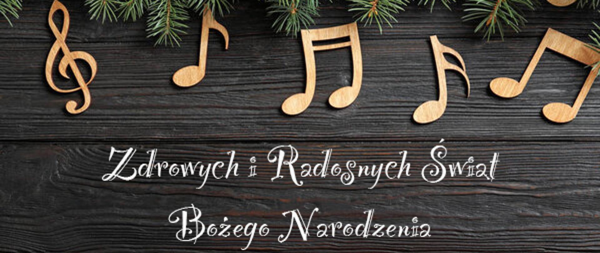 Plakat w świątecznej tonacji z kolorowymi nutkami i napisem: Zdrowych i Radosnych Świąt Bożego Narodzenia. 