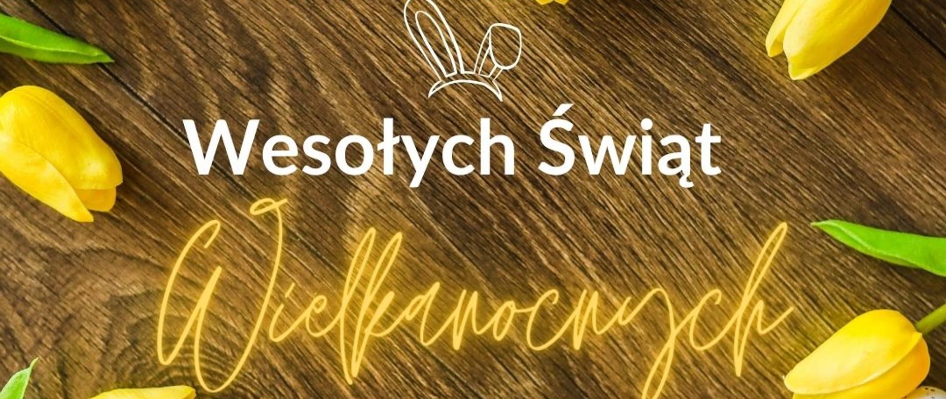 Grafika przedstawia napis wesołych świąt Wielkanocnych . Wokół znajdują się żółte tulipany z białymi jajeczkami.