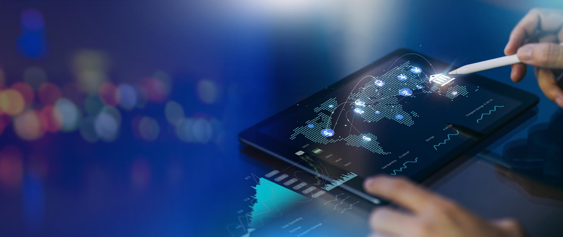 Tablet na którym widać mapę świata na granatowym tle