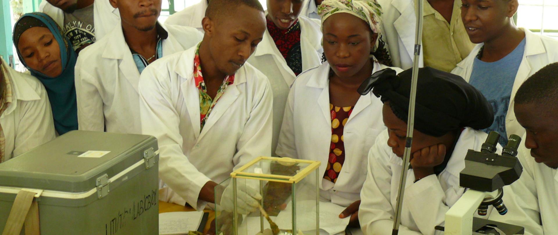 Grupa ludzi w pracowni z mikroskopami 