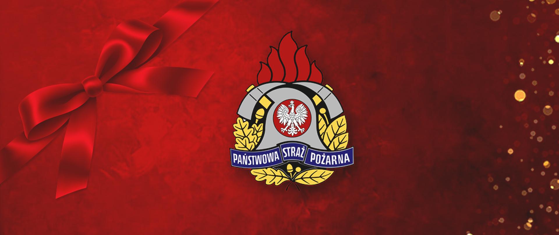 Na zdjęciu po lewej czerwona kokarda oraz centralnie umieszczone logo PSP w wersji kolorowej. Tło w odcieniach czerwieni.