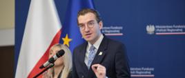 In the photo: Deputy Minister Jan Szyszko on stage in front of the microphone, with the Polish and EU flags in the background
