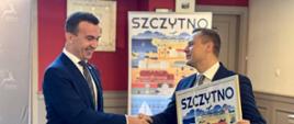Wręczenie plakatu z grafiką przedstawiającą miasto Szczytno