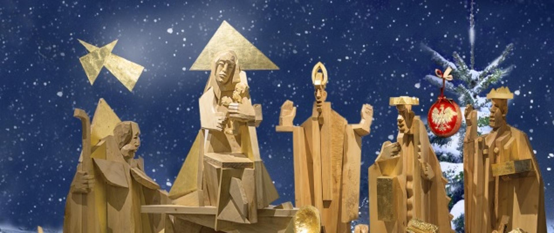 Kartka z postaciami z szopki bożonarodzeniowej wyrzeźbione w drewnie. Pod spodem życzenia pani dyrektor Joanny Nowrot z cytatem Jana Pawła II