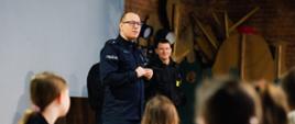 Policjant prowadzi prelekcję na temat bezpiecznego wypoczynku podczas ferii zimowych