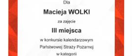 Widoczny dyplom Komendanta Głównego PSP dla Macieja Wolko za zajęcie III miejsca w konkurie KG PSP w kategorii gra planszowa