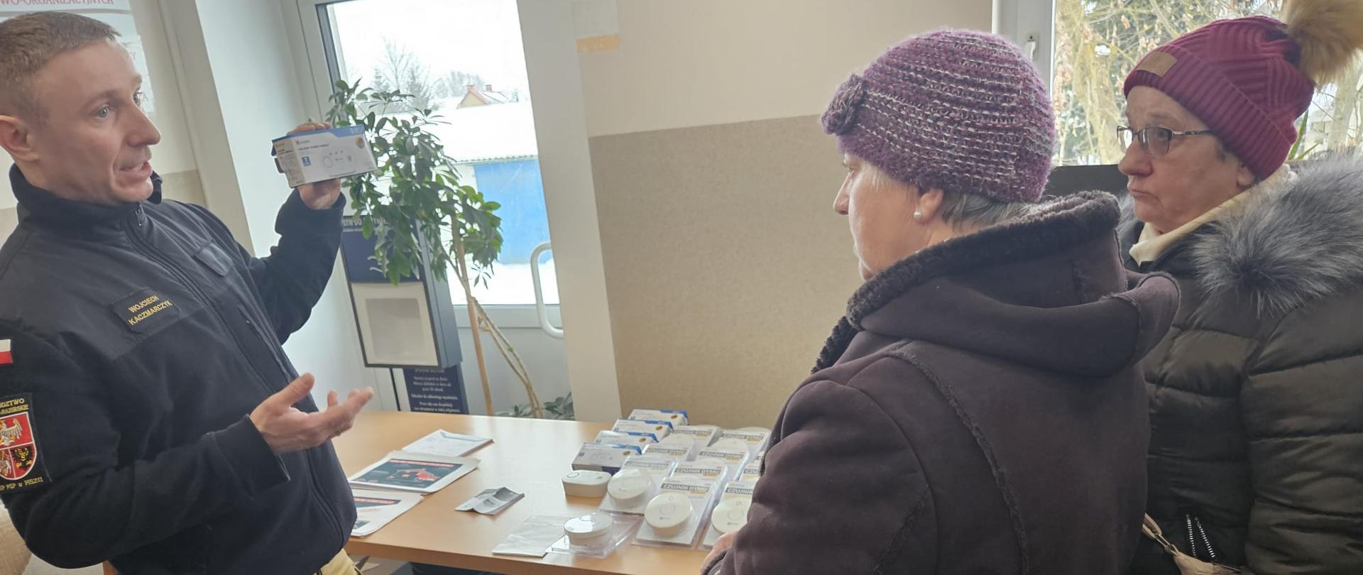 Strażak pokazujący działanie czujki dla kobiet.