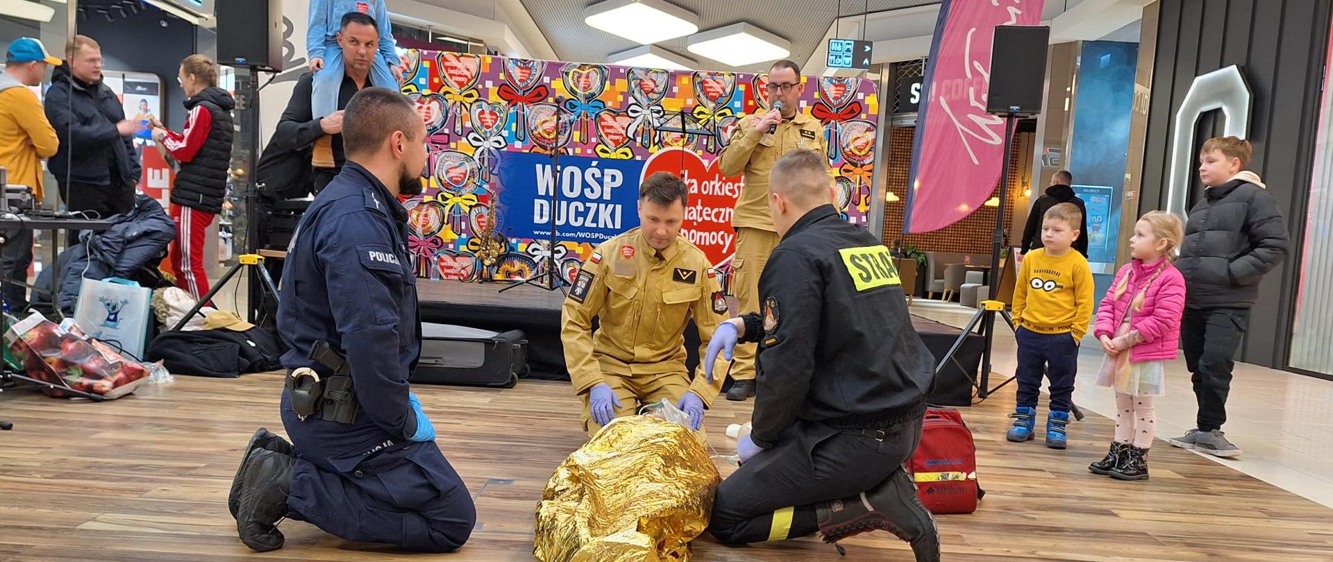 Na zdjęciach widoczni są funkcjonariusze prezentujący zasady pierwszej pomocy, obsługi czujek tlenku węgla oraz dymu i inne przedsięwzięcia podnoszące bezpieczeństwo. Stoiska i pokazy w ramach 32 finału WOŚP.