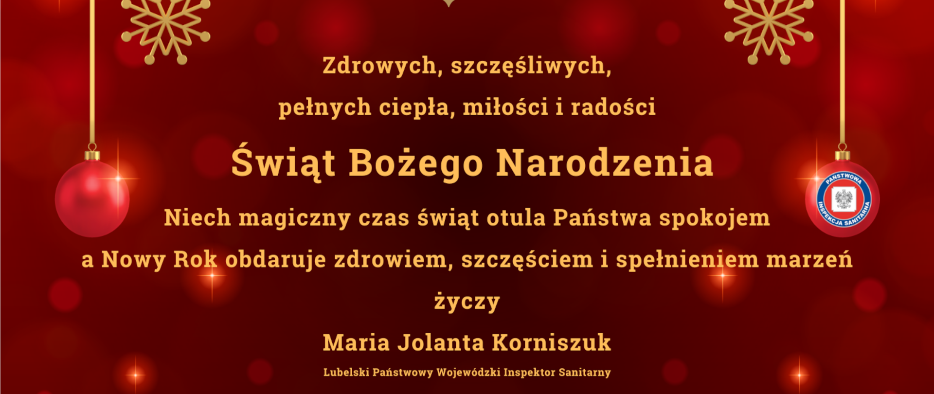 Na czerwonym tle napis: Zdrowych, szczęśliwych, pełnych ciepła, miłości i radości Świat Bożego Narodzenia Niech magiczny czas świat otula Państwa spokojem a Nowy Rok obdaruje zdrowiem, szczęściem i spełnieniem marzeń życzy Maria Jolanta Korniszuk Lubelski Państwowy Wojewódzki Inspektor Sanitarny